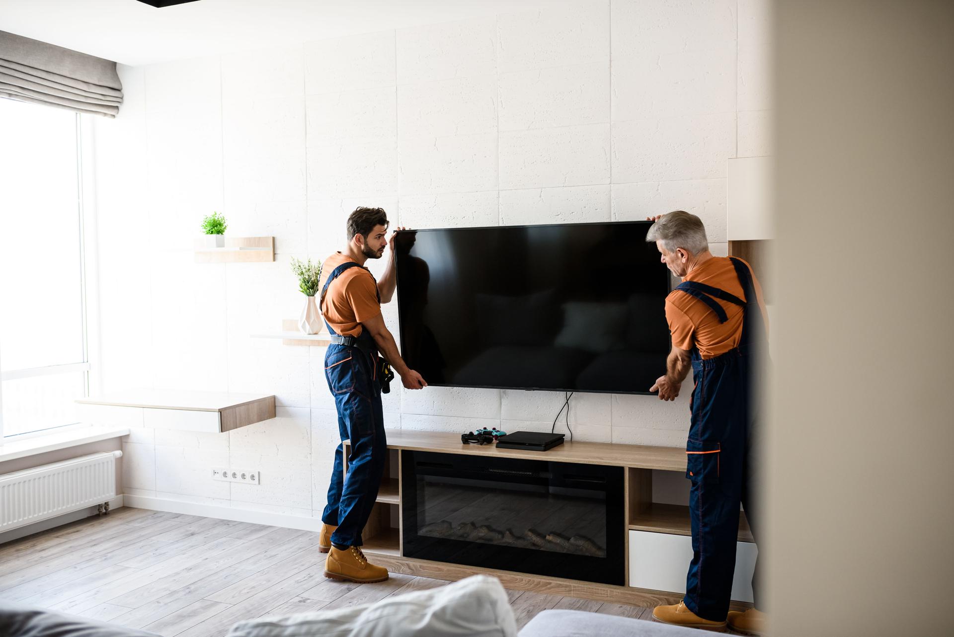 A little assistance for you. Two Service Tech's, workers in uniform hanging, installing tv television on the wall indoors. Furniture Assembly, Installation, TV Mounting, Labor-Only Hourly Helper's Service's, Serving: NORTHERN-VIRGINIA, EASTERN-PANHANDLE WV, WASHINGTON DC, & MONTGOMERY COUNTY, MD.